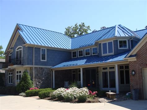 grey siding house with gallery blue metal roof|gray house with blue roof.